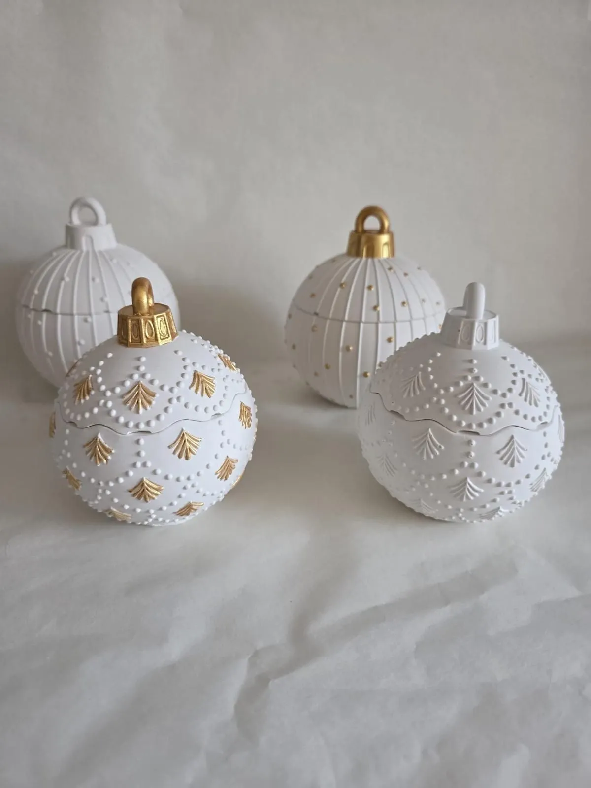 Handmade white bauble candles with detailed gold accents